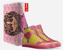 a pair of pink and yellow lil pump sneakers next to a box