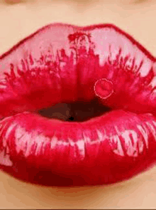 a close up of a woman 's red lips with a heart in the middle .