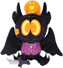 a stuffed bat with a pumpkin on its head