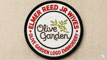 a patch that says elmer reed jr wives olive garden logo embroidery on it