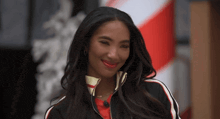 a woman wearing a black and red jacket and red lipstick