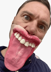 a man wearing a mask with his tongue out