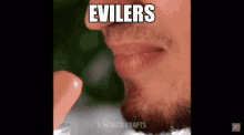 a close up of a man 's mouth with the words " evilers " written above it