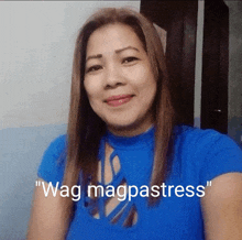 a woman in a blue shirt with the words " wag magpastress " on the bottom right