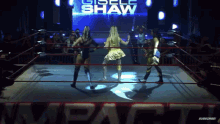 three women in a wrestling ring with the name giselle shaw on the screen behind them