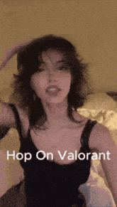 a woman in a black tank top with the words hop on valorant on the bottom