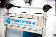 a cart with a sign that says sanitet sverige ab on it