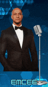 a man in a tuxedo stands in front of a microphone with the word emcee written below him