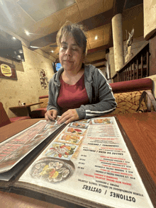 a woman looks at a menu for oysters