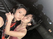 a girl kissing another girl on the forehead