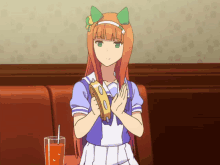 a girl is holding a tambourine and a glass of orange juice in front of her