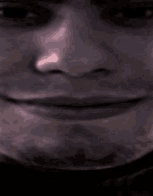 a close up of a man 's face with a smile on it .