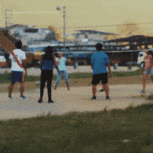 a group of people are playing volleyball in a field with la guarimba film festival written on the bottom right