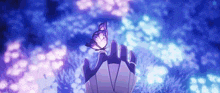 a person is holding a butterfly in their hand in a field .