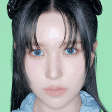 a close up of a woman with blue eyes