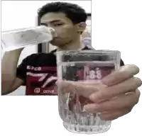 a man is drinking water from a bottle while holding a glass