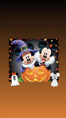 mickey mouse and minnie mouse are dressed in witch costumes and sitting on a pumpkin