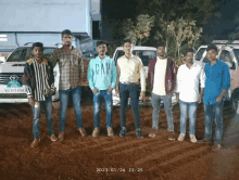 a group of young men are posing for a photo with one wearing a gap sweatshirt