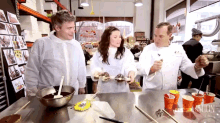 a group of people are standing around a table with cups and spoons and the word nation on the bottom right