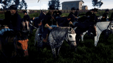 a group of men are riding horses in a field and one of them is wearing a hat with a cross on it