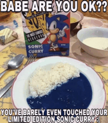 a box of sonic curry sits next to a plate of rice