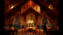 a church decorated for christmas with a cross on the ceiling