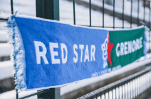 a blue and green scarf with the words red star grenore on it