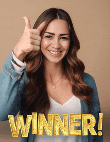 a woman is smiling and giving a thumbs up with the word winner behind her