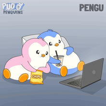 two penguins sitting next to each other with a bag of chips in front of a laptop