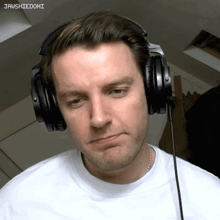 a man wearing headphones with jawshiedomi written on the bottom right