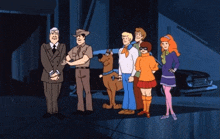 a group of scooby doo characters standing in front of a car