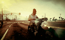 a man is riding a motorcycle down a street with a sunset in the background