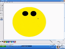 a computer screen shows a yellow smiley face with a black mouth