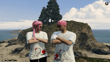 a man and a woman standing on a beach wearing matching shirts