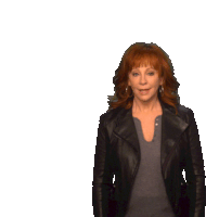 a woman with red hair is wearing a black jacket and a grey shirt