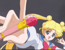 a girl in a sailor moon uniform is holding a pink wand