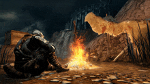 a man sits in front of a campfire with a sword in his hand