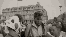 a black and white photo of a man in a jacket