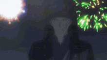 a man with long hair and a black hat stands in the dark