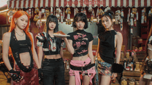 a group of girls standing in front of a store with a sign that says ' a '