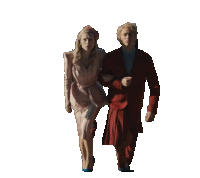 a man in a red suit and a woman in a white dress are walking