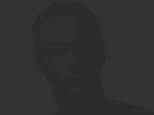 a silhouette of a man 's face is against a dark background .