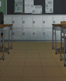 a person sits at a desk in a classroom with a bulletin board with papers on it