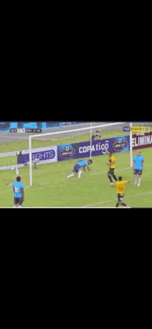 a soccer game is being played on a field with advertisements for copatico