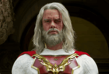 a man with gray hair and a beard is wearing a white and red superhero costume