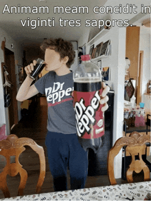 a boy in a dr pepper shirt drinks a soda