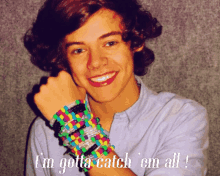 a young man with a bunch of bracelets on his wrist and the words i 'm gotta catch ' em all