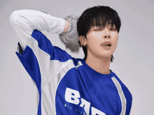 a man wearing a blue and white shirt that says bad on it