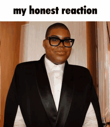 a man wearing glasses and a tuxedo has the words my honest reaction above him