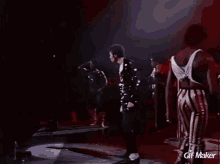 a man is dancing on a stage with a gif maker watermark
